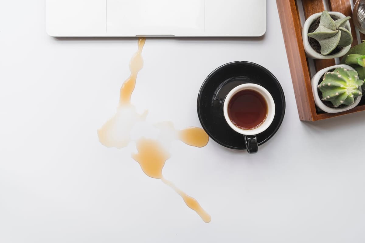 A coffee cup spilled across a workspace