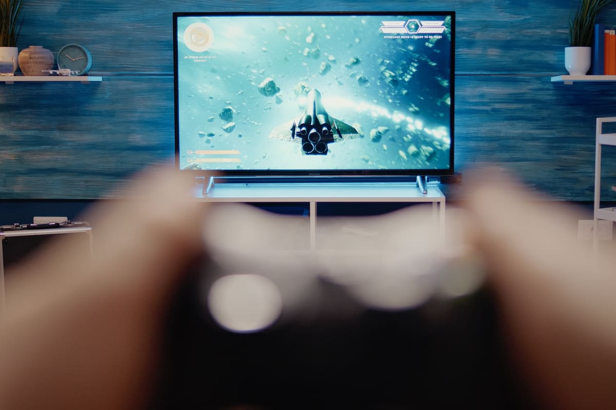 A gaming setup in front of a TV in a modern living room